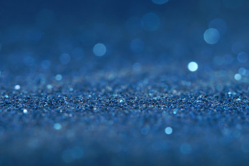 blue Sparkling Lights Festive background with texture. Abstract Christmas twinkled bright bokeh defocused and Falling stars. Winter Card or invitation	
