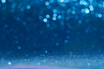 blue Sparkling Lights Festive background with texture. Abstract Christmas twinkled bright bokeh...