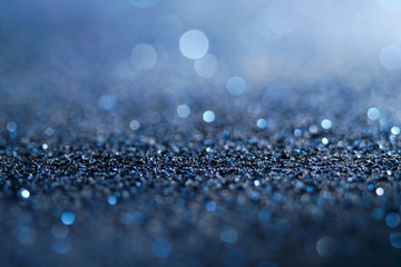 blue Sparkling Lights Festive background with texture. Abstract Christmas twinkled bright bokeh defocused and Falling stars. Winter Card or invitation	