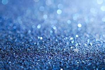 blue Sparkling Lights Festive background with texture. Abstract Christmas twinkled bright bokeh defocused and Falling stars. Winter Card or invitation	