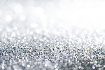 Silver Sparkling Lights Festive background with texture. Abstract Christmas twinkled bright bokeh defocused and Falling stars. Winter Card or invitation	