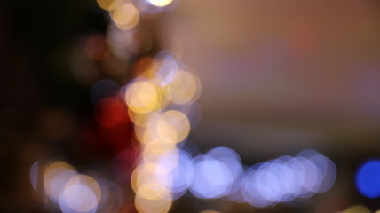 Christmas illuminations with blurred effect. Red & white light sparkle on glitter ornaments. Celebration design. Bright abstract texture. Background colorful holiday night. Blurry xmas festive party. 