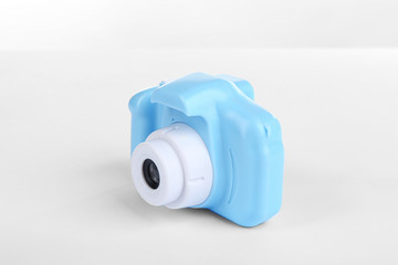 Light blue toy camera isolated on white