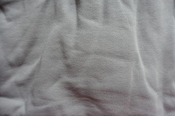 Surface of jammed light grey cotton fabric from above