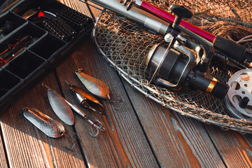 fishing rods and tackles on the wooden background