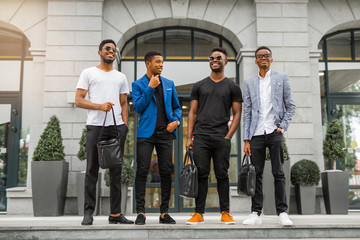 four handsome young african men on the background of the building