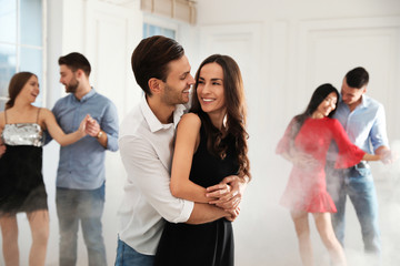 Lovely young couple dancing together at party