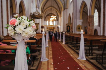 Church sanctuary before a wedding ceremony. Empty chairs for bride and groom.