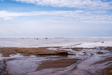 winter landscape on the North Baltic sea in calm colors with the bed of a small river