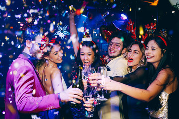 Group of friends having fun and toasting at New Year's party