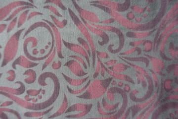 Pink floral pattern on grey cotton fabric from above