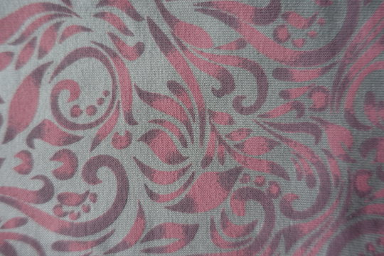 Pink floral pattern on grey cotton fabric from above