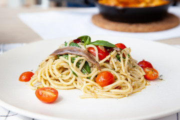 Spaghetti with anchovy, cherry tomato, onion, chili and pamersan cheese