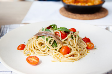 Spaghetti with anchovy, cherry tomato, onion, chili and pamersan cheese