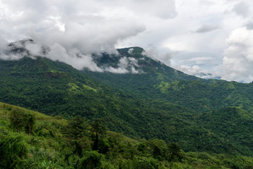 Obraz premium beautiful blue sky high peak mountains mist fog wildlife green forest at Khao Koh, Phu Tub Berk, Phetchabun, Thailand guiding idea long weekend for backpacker camping campfire relaxing hiking