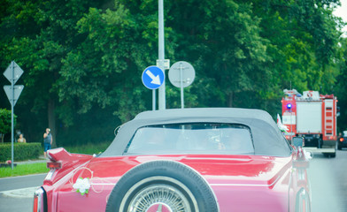 Luxury wedding car decorated with beautiful flowers. Brides and grooms wedding day.