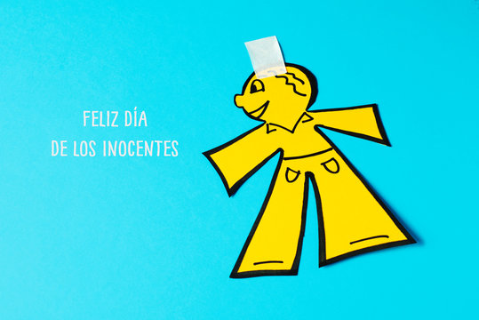 paper man and text happy innocents day in spanish.