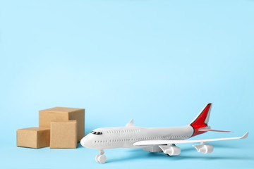 Toy plane on blue  background, space for text. Logistics and wholesale concept