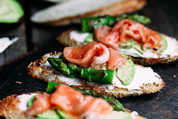 Sandwich with cream cheese, avocado, asparagus and salted salmon
