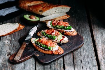 Sandwich with cream cheese, avocado, asparagus and salted salmon