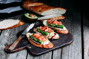 Sandwich with cream cheese, avocado, asparagus and salted salmon