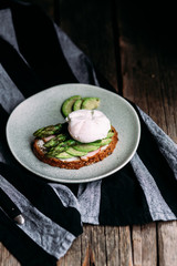 Sandwich with cream cheese, avocado, asparagus and poached egg
