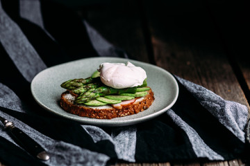 Sandwich with cream cheese, avocado, asparagus and poached egg