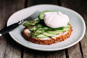 Sandwich with cream cheese, avocado, asparagus and poached egg