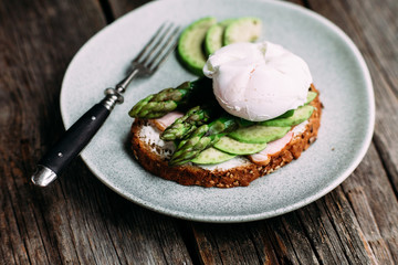 Sandwich with cream cheese, avocado, asparagus and poached egg