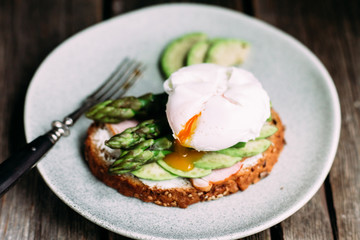 Sandwich with cream cheese, avocado, asparagus and poached egg