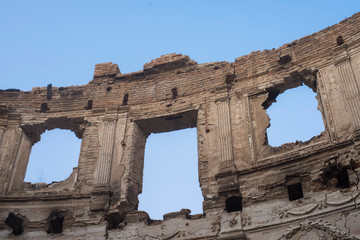 Naklejka premium Landscape of ruined buildings on the blue sky background , image of decrepitude or natural time disaster. The detail of old house sight