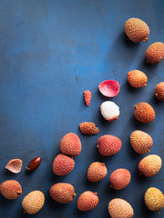 Lychee exotic fruits, organic, fresh and peeled showing the red skin and white flesh on trend...
