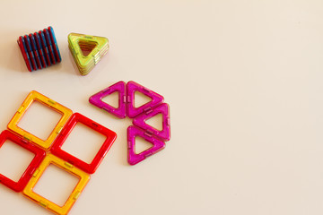 Children's Magnetic designer for the development of motor skills, thinking and imagination. Construction of multi-colored parts of the children's designer. children's game isolated on white background