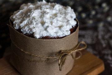 One cake on a dark background. Cake with white icing. Birthday cake. palm Sunday. Pie and willow branches. Wonderful decoration. Homemade delicious and beautiful pastries. bow of rope.