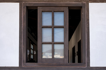 Brown wooden window opened on wall