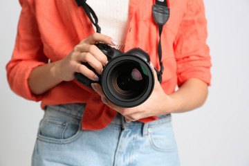 Professional photographer working on white background in studio, closeup