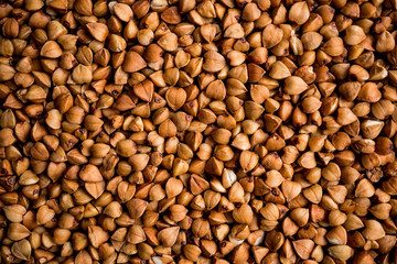 The texture of dry buckwheat. Background image of buckwheat porridge. Maro's Photo