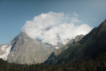 Fototapeta premium Clouds over the mountain peak.
