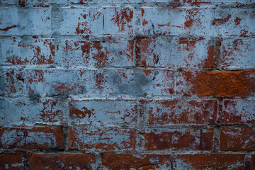 Texture of an old paint covered brick wall. Background image of an abandoned brick wall with painted over paint