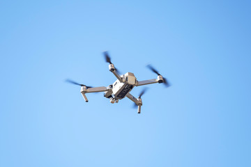 Drone flies in the blue sky 2