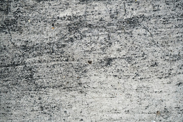 Texture of an old cracked concrete wall. Background image of a worn gray concrete surface