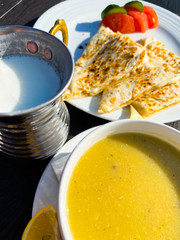 Soup mashed, pita, tomatoes stand on a table against the background of a blurred city landscape. Turkey. Dinner. Tourism.