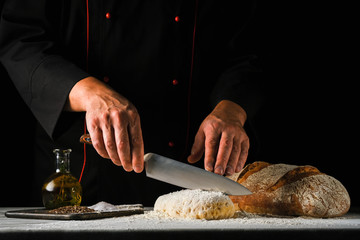 the process of making whole grain bread the chef cuts the dough with a knife - Powered by Adobe