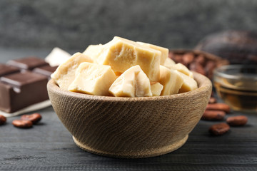 Organic cocoa butter on black wooden table, closeup