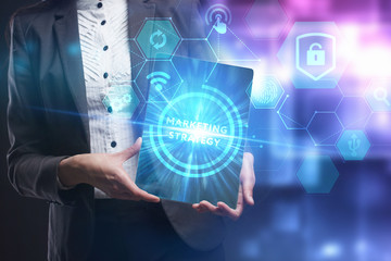 Fototapeta premium Business, Technology, Internet and network concept. Young businessman working on a virtual screen of the future and sees the inscription: marketing strategy