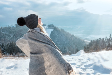Happy woman traveler on the snowy of mountain look on the nice w