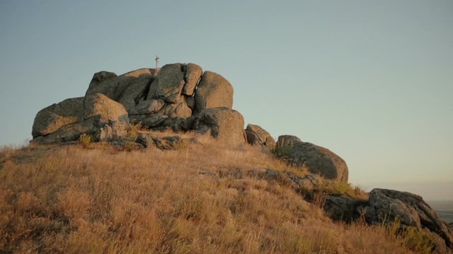 Cross On A Top Of A Stone At Sunset