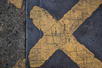 Yellow lines on the road and the water  cover are cross.