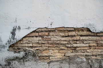 The white wall broke inside of the orange bricks.