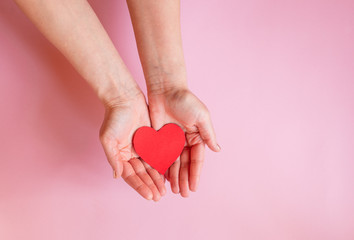 hands holding red heart on blue background, health care, hope, love, organ donation, wellbeing, family insurance and CSR concept, world heart day, world health day, National Organ Donor Day